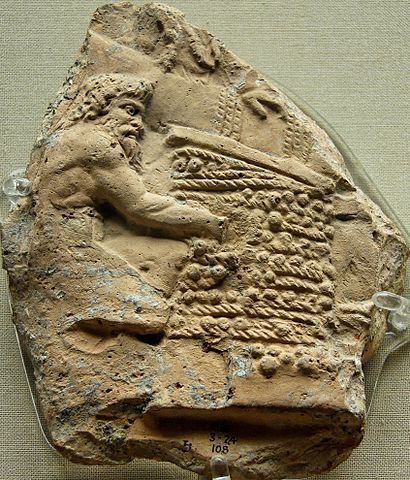 A terra cotta relief showing Satyrs, a Greek mythological creature, expressing the juice from trodden grapes in wicker mats