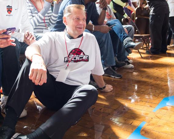 Father Dr. Michael Louis Pfleger, Senior Pastor of St. Sabina Church in Chicago, taking in the 2013 Peace League Basketball Tournament. Photo by Michael Yen