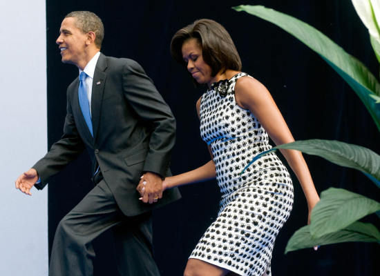 The President and First Lady arrive for a graduation at the New Economic School in Moscow on Tuesday.