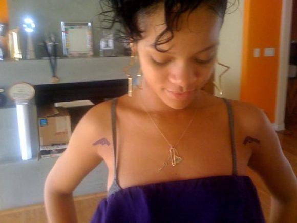 brown tattoo. Rihanna Gets A Gun Tattoo