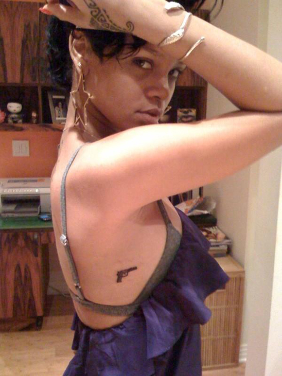 star tattoo behind ear. Rihanna Gets A Gun Tattoo