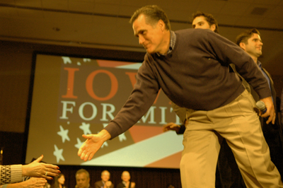 Romney shakes hands with supporters at his rally.