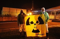 Kumi Naidoo Executive Director of Greenpeace International (left) and Tobias Muenchmeyer, Nuclear Expert Greenpeace Germany (right) hold an anti-nuclear banner in the very minute of the Chernobyl 25th anniversary.