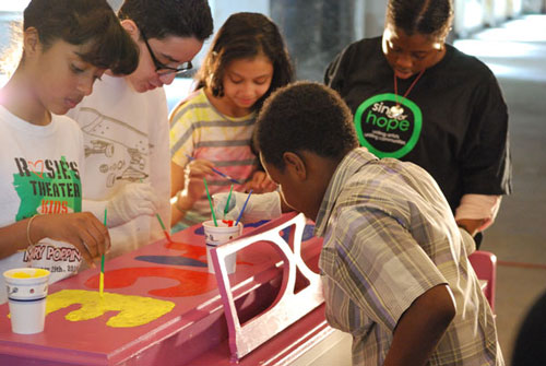 Students from PS34 paint a 2013 Sing for Hope Piano