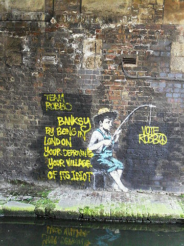 2013-11-01-360pxBanksy_fisherman_mural_Regents_Canal_Camden_London26April2010.jpg