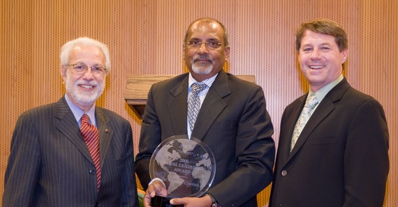 Ciro de Quadros and Orin Levine deliver the PACE Global Leadership Award to WHO's Thomas Cherian, 2010