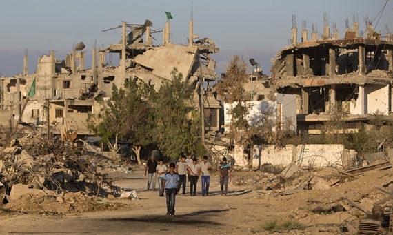 2014-09-16-Photo2_Gaza_Image_Getty_Palestinianboyswalkpastbuildings.jpg