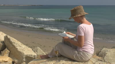 2014-12-03-stockfootagebeautifulwomanreadinganddrinkingwhitewineonthebeach.jpg