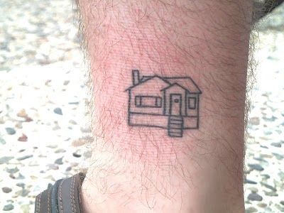 Micro-realistic house tattoo located on the chest.