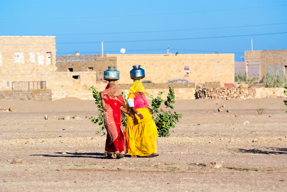 2015-03-19-1426727134-1720345-bigstockWomenCarryingWaterInRajast70079095.jpg