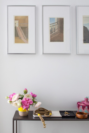 Entryway vignette with peony ranunculus flower arrangement and color block tray by Decor Aid