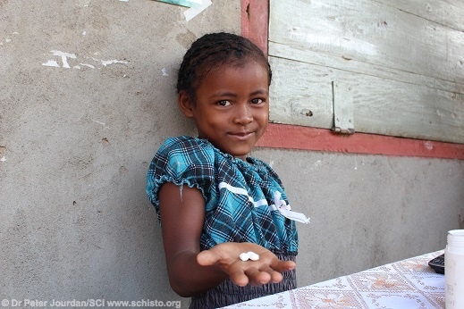 A girl in Madagascar shows the deworming tablets provided to her by the Schistosomiasis Control Initiative, one of the most effective charities in the world