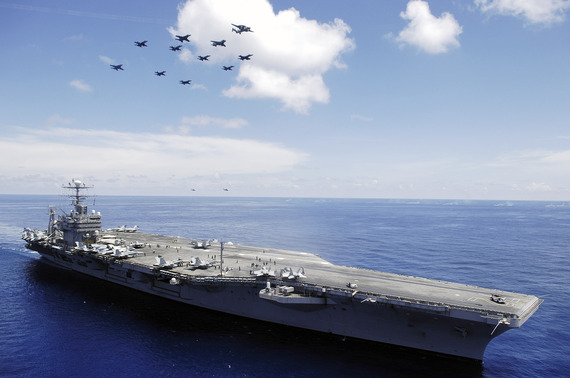 2015-06-26-1435308304-7712626-US_Navy_060508N4166B030_The_Nimitzclass_aircraft_carrier_USS_Abraham_Lincoln_CVN_72_and_aircraft_assigned_to_Carrier_Air_Wing_Two_CVW2_perform_an_aerial_demonstration_in_the_South_China_Sea.jpg