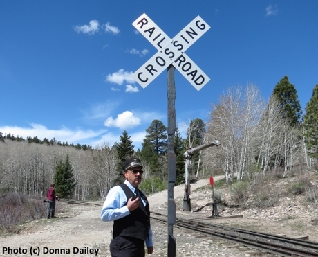 2015-06-30-1435707681-7789934-Cumbres_Toltec_Scenic_Railroad_9_conductor_Ray_Martinez_and_Railroad_Crossing_sign.jpg