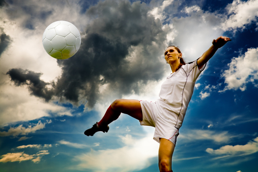 2015-07-08-1436397712-1973628-Womanplayingsoccerinfrontofcloudsshutterstock_526111091.jpg