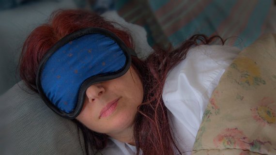 woman sleeping with a sleep mask