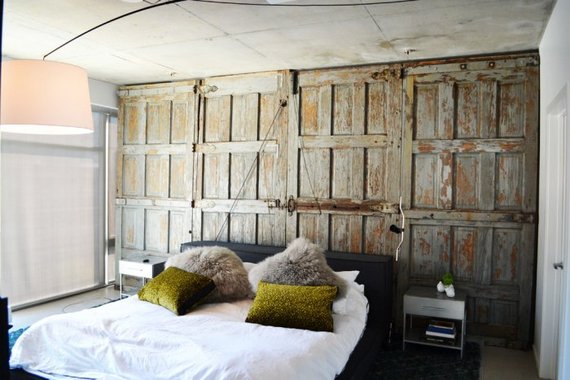 bedroom with an old barndoor as a wall