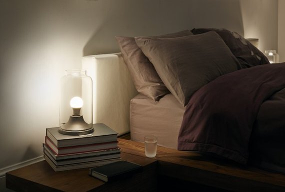 nightstand with glass of water and light
