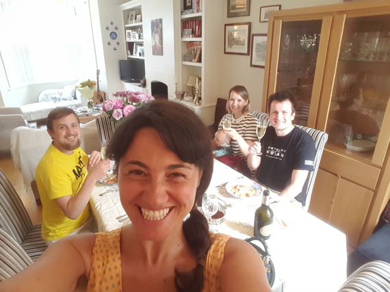 Mariacristina and George sitting at the dining table with George's stem cell donor Tim and his family
